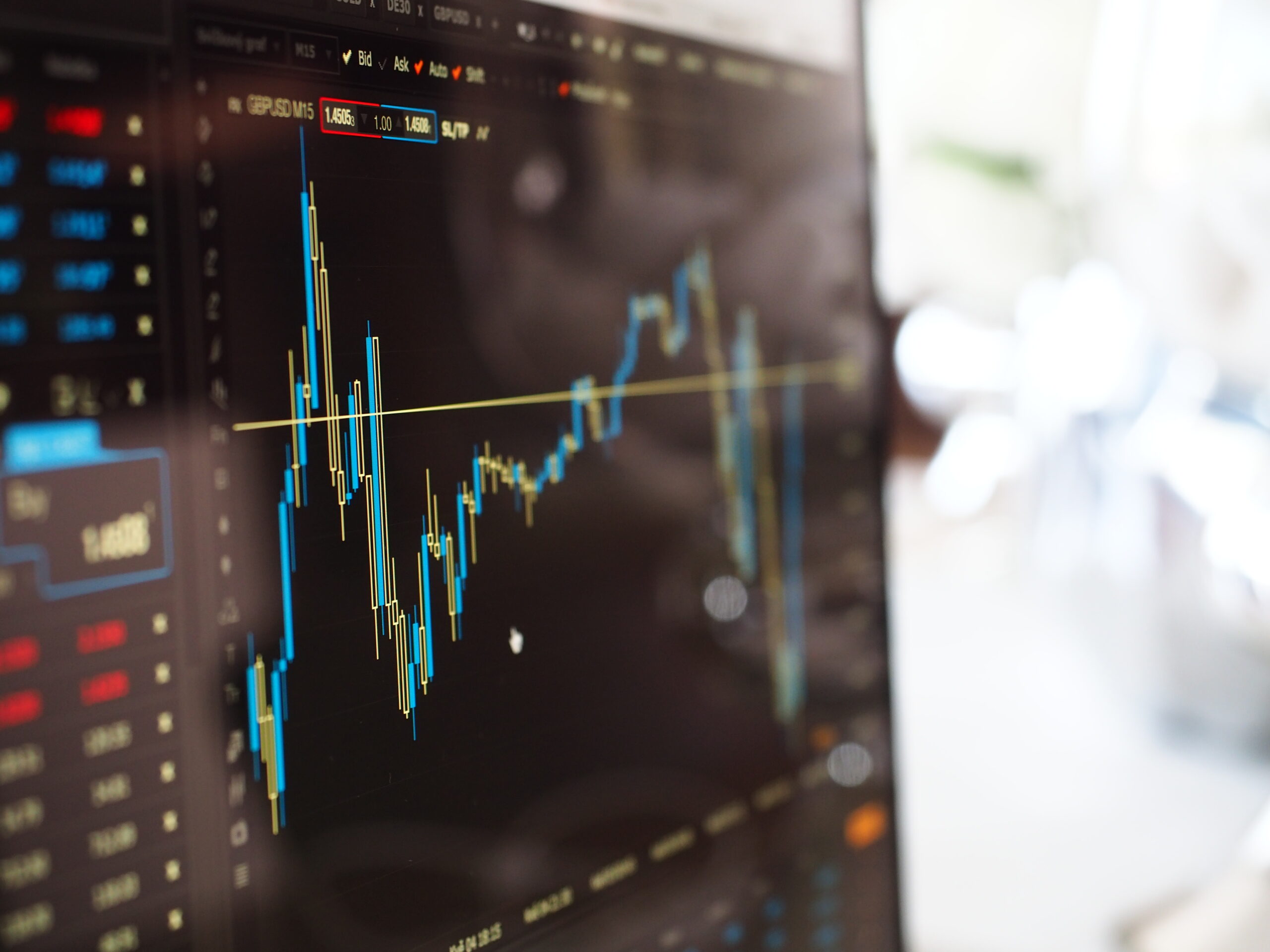 Blue and yellow graph on stock market monitor